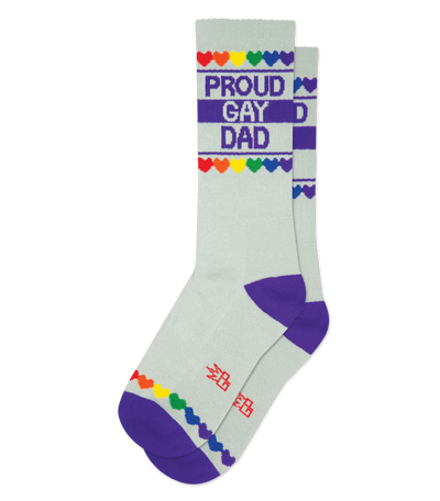 "Proud Gay Dad" text on white sock with rainbow hearts, gray body, red accents, and purple toe.