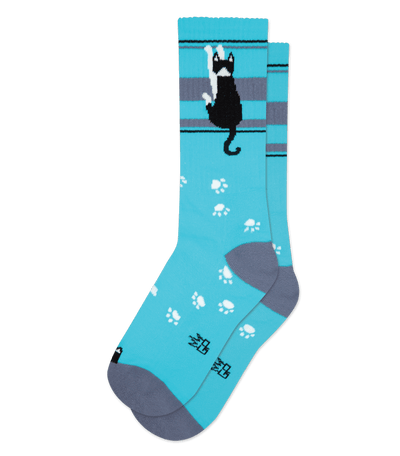 Teal sock with black cat design, paw prints, and stripes, no background color.