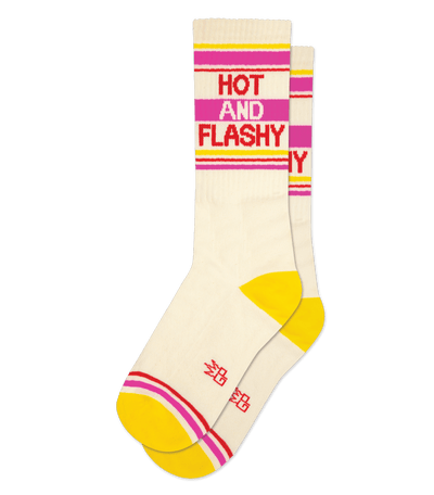 Alt text: Pair of natural cotton socks with yellow accent, text "HOT AND FLASHY" on the leg, no background color.