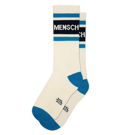 Natural cotton socks with cream accents, blue tips, and “MENSCH” text. Japanese symbols below arch.