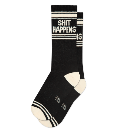 Black socks with cream accents. Text reads "SHIT HAPPENS." Cream toes and stripes at the cuff and toe.