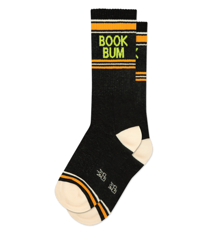 Black socks with cream accents and "Book Bum" text; orange stripes adorn the cuff and toe area.