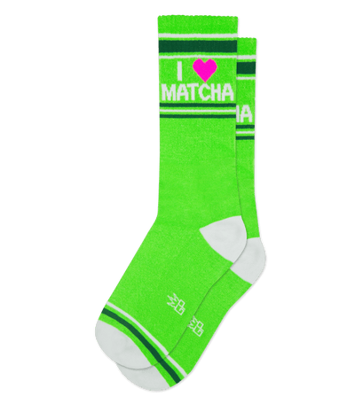 "Green socks with ruby pink accent say 'I ♥ MATCHA' at top. White heel and toe accents visible."