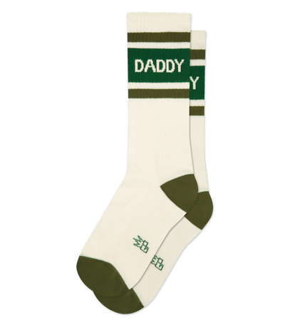 Natural cotton socks with green accents and text "DADDY" on top; cream heel and toe.