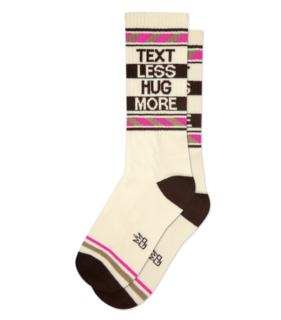 Cotton sock with "TEXT LESS HUG MORE" slogan, natural body, light brown accents, and no background.