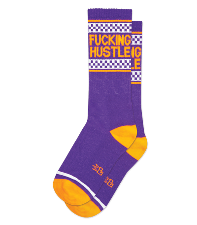 Purple sock with white text, checkerboard pattern at the top, and orange accents.