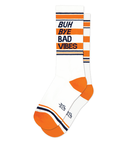 White socks with orange stripes and text that reads "BUH BYE BAD VIBES" on an isolated background.